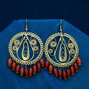 Gold tone hoop earrings with dangling wood beads.
